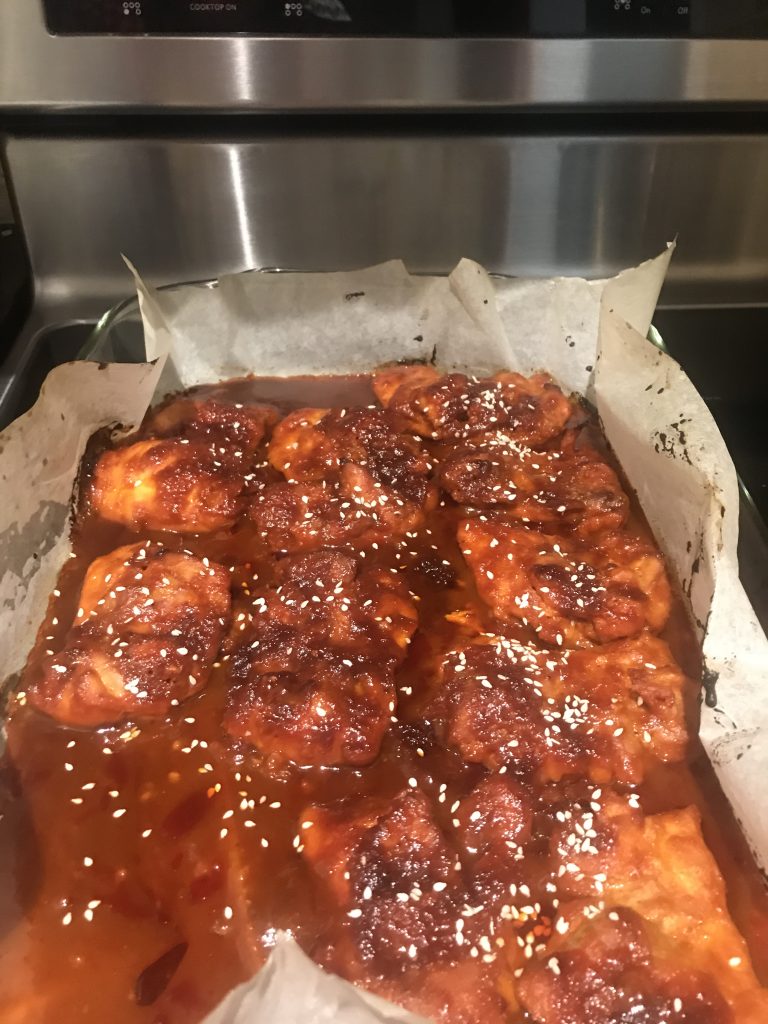 Lining the pan with parchment makes cleanup super easy for Korean BBQ chicken